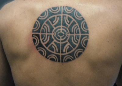 Tattoo of a Maya inspired design on male shoulders