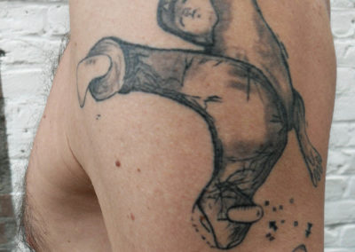 Healed tattoo of a skater, symbolizing an accident.