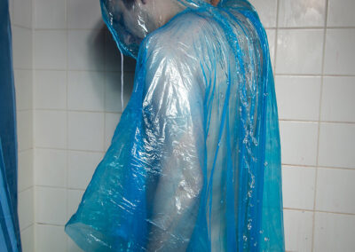 Artistic nude portrait of Thilo taking a shower in a rain-cape.