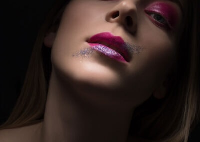 Beauty shot of a young woman with pink makeup and lips